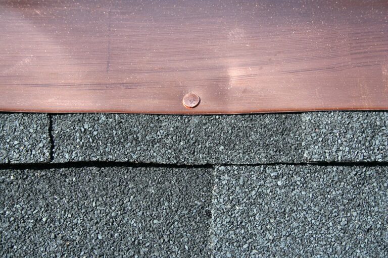 Black asphalt roofing shingles with copper flashing